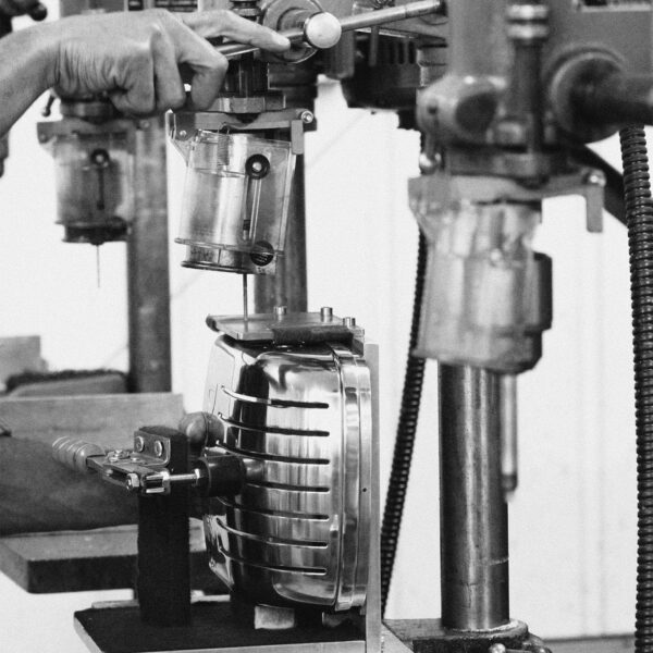 Hand assembling a Dualit DA0144 6 Slice Vario Toaster in a workshop.