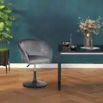 Homcom Grey Fabric Swivel Bar Stool Next to a Table in a Stylish Room with Dark Green Walls