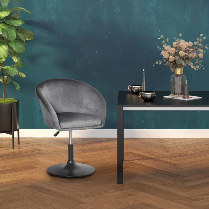 HOMCOM grey fabric swivel bar stool next to a table in a stylish room with dark green walls.