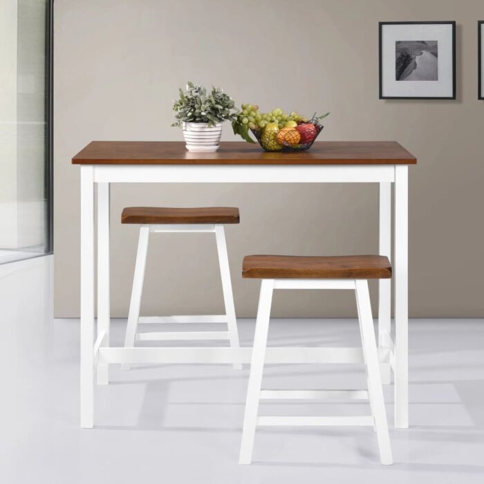 vidaXL bar table and two stools in solid wood, white legs with contrasting dark brown top, decorated with fruit bowl.